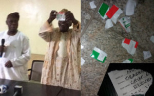 Ward 11 chairman, Usman Oladunjoye tearing Obasanjo's PDP membership card and the torn card