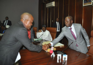 The Chairman (now suspended) of Etsako West Local Government Area, Mr Alhassan Mohammed in handshake with Governor Adams Oshiomhole, after taking his oath of office, Tuesday.