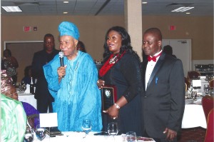 Barrister F.I. Osemwengie, with his daughter and community development and innovations award recipient, Mrs. Dala Girolamo (on his left) makes remarks after the award presentation. Seated on his immediate right is his wife, Deaconess A.A. Osemwengie while the president of The League of Committed Friends, Mr. Okunmwendia (right) and others look with rapt attention.