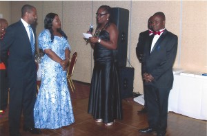 From left, Mr. Ewaen and Apostle (Mrs.) Naomi Osagiede, community development and innovations award recipients listen as their citation was being read by Attorney (Dr.) Rose Egbuiwe while the president of the organization, Mr. Emmanuel Okunmwendia and Desmond Edebiri event planning committee chairman listen.