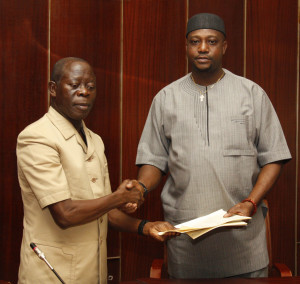 Governor Adams Oshiomhole presents copies of the 2016 Appropriation Act to Rt Hon Victor Edoror, Speaker Edo State House of Assembly (right), after signing the Bill into Law at the Government House, yesterday