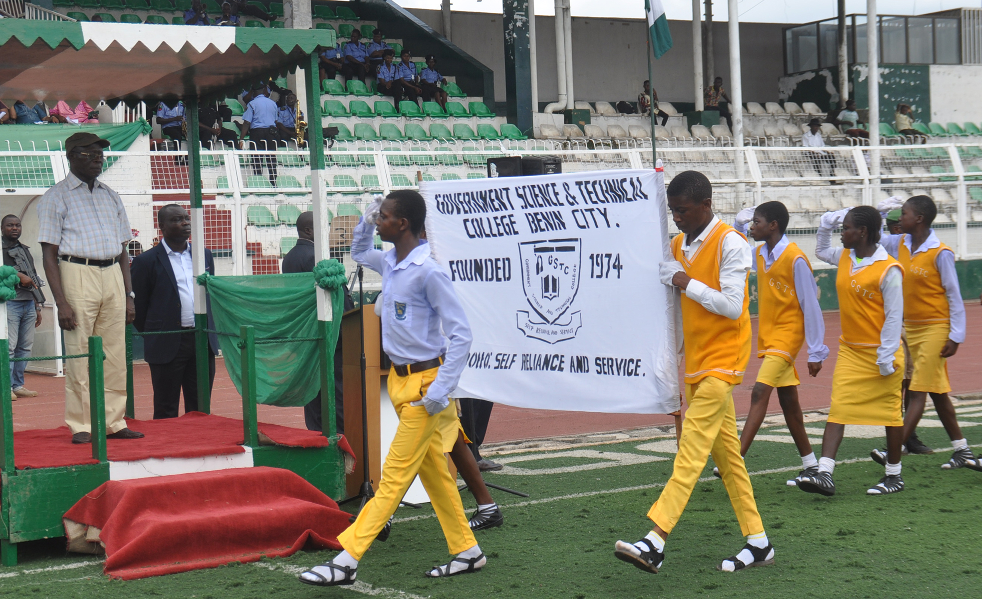 Governor Adams Oshiomhole of Edo State takes a salute from students of Government Science and Technical College, Benin City during a march past at the 2016 Children's Day celebration in Benin City, Friday.