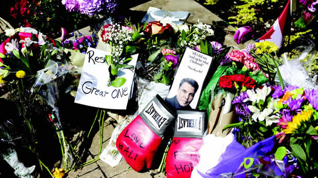 Flowers and boxing gloves dropped by people to pay their respects to boxing legend Muhammad Ali at the Muhammad Ali Center in Louisville, Kentucky, U.S 